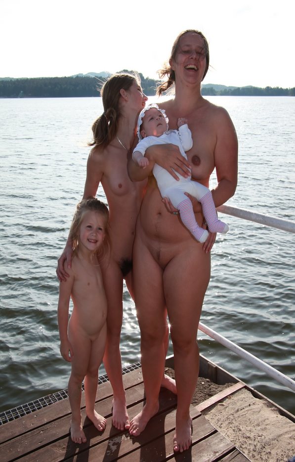 Mother and daughters nudists of a photo on the lake Mother and daughters nudists of a photo on the lake