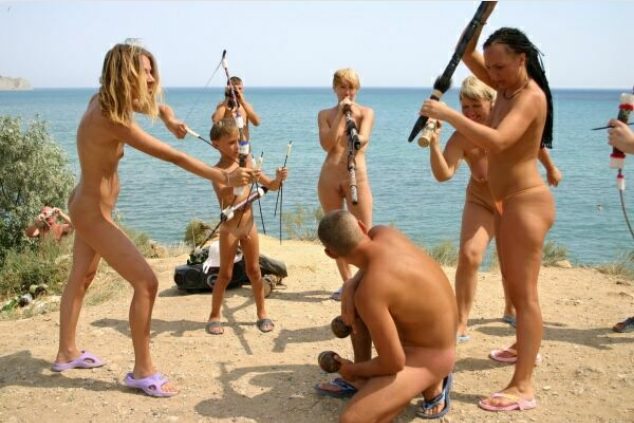 Nudists on a beach play Indians Nudists on a beach play Indians